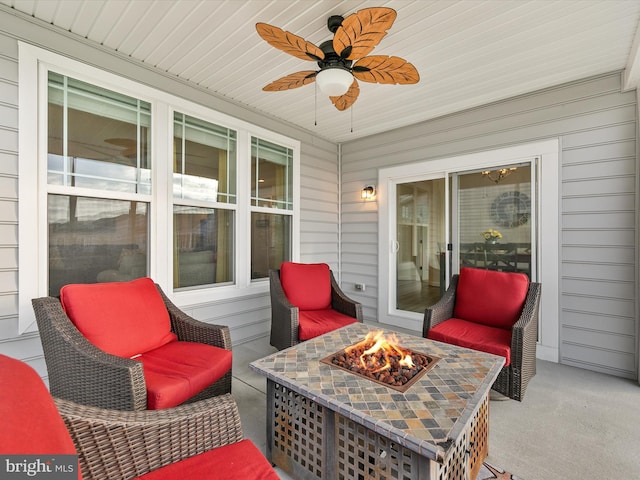 view of patio / terrace featuring ceiling fan and an outdoor fire pit