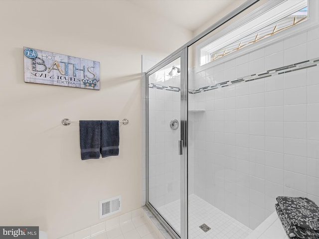 bathroom with tile patterned flooring and an enclosed shower