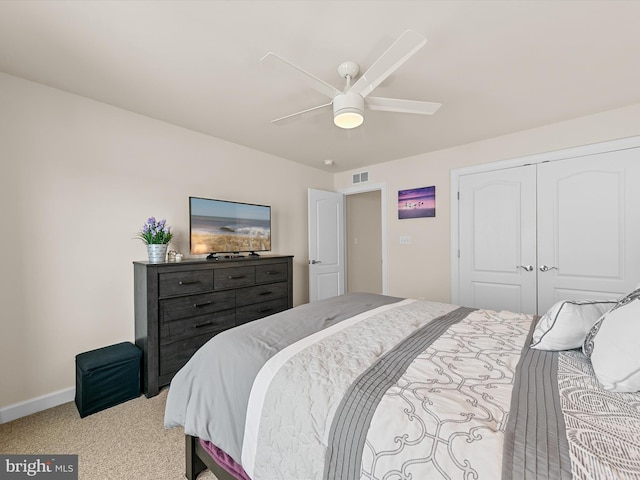 carpeted bedroom with a closet and ceiling fan