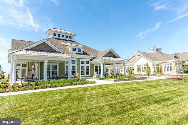 view of front of home featuring a front yard and a porch