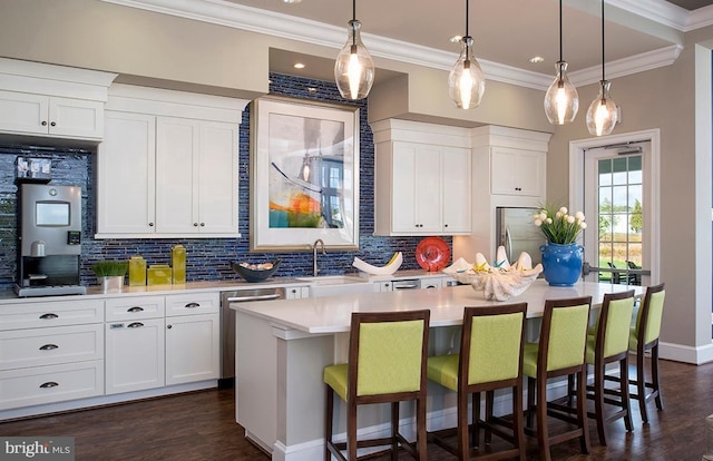 kitchen with a kitchen island with sink, dark hardwood / wood-style flooring, white cabinets, and appliances with stainless steel finishes