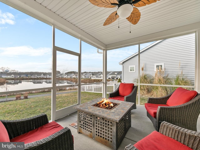 sunroom with a water view, ceiling fan, a healthy amount of sunlight, and wood ceiling