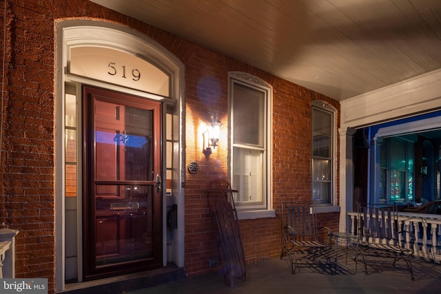 view of exterior entry with a porch