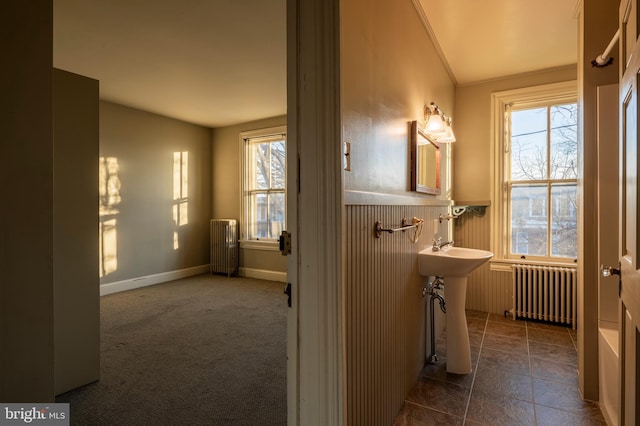 bathroom with radiator and vaulted ceiling