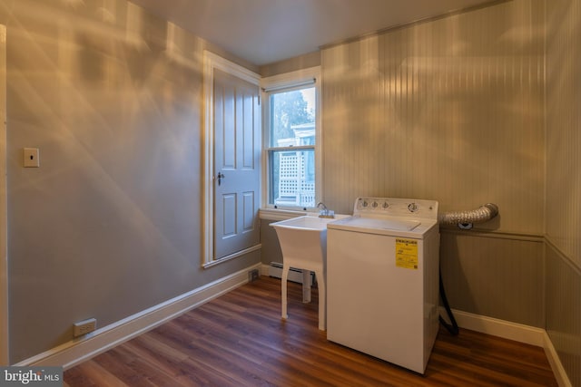 clothes washing area with dark hardwood / wood-style flooring, washer / dryer, and sink