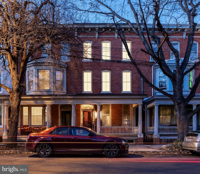 townhome / multi-family property featuring a porch