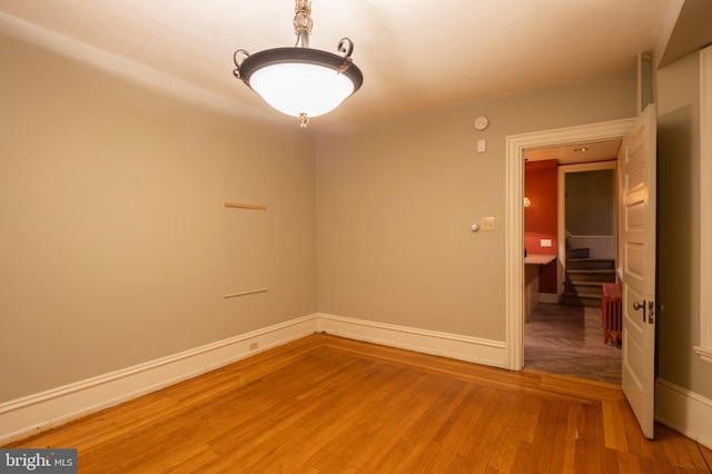 empty room with hardwood / wood-style floors