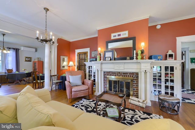 living room with a fireplace, wood-type flooring, a wall unit AC, and crown molding