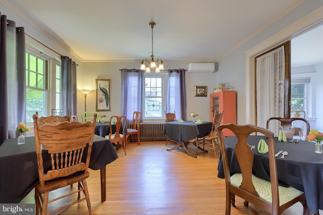 dining space featuring a chandelier, crown molding, light hardwood / wood-style floors, and a wall mounted air conditioner