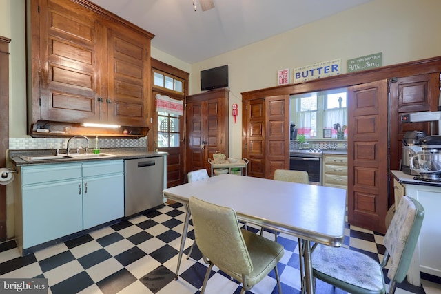 kitchen featuring dishwasher, white cabinets, sink, ceiling fan, and decorative backsplash