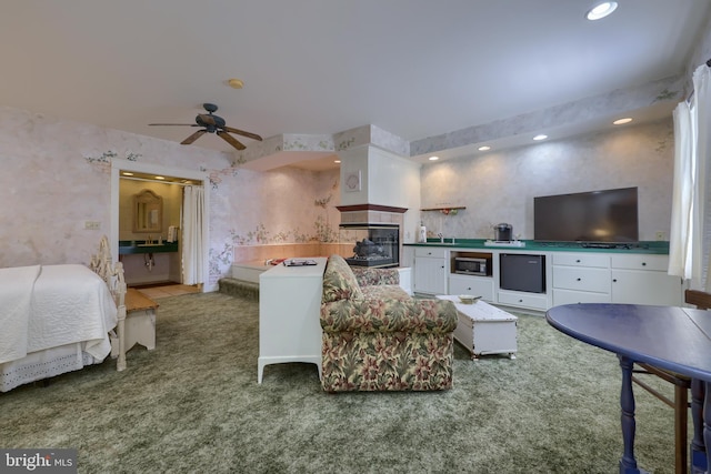 living room featuring carpet, ceiling fan, and a multi sided fireplace