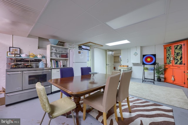 dining area featuring a drop ceiling