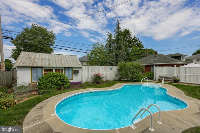 view of swimming pool with a patio and an outdoor structure