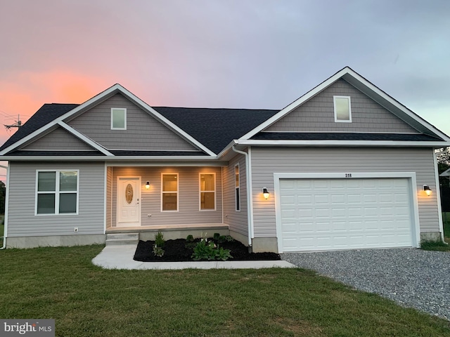 view of front of house with a garage and a lawn