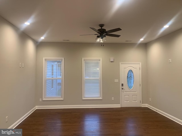 entrance foyer with ceiling fan and dark wood-type flooring