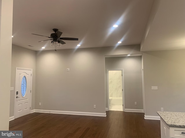 foyer with dark hardwood / wood-style floors and ceiling fan