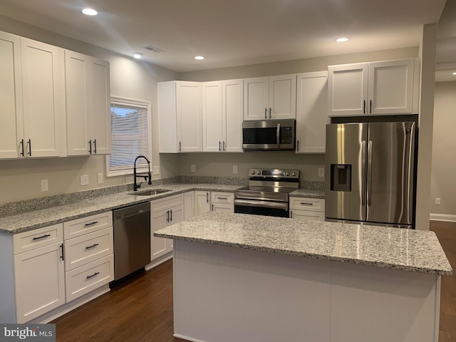 225 Wildwood Rd, Colonial Beach, VA 22443 - kitchen with appliances with stainless steel finishes, dark wood-style flooring, white cabinetry, a center island, and recessed lighting