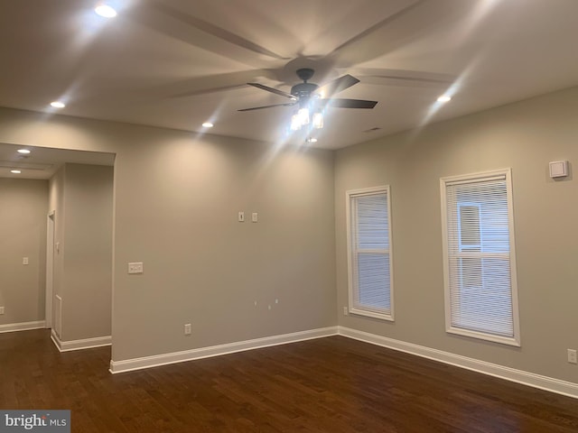 empty room with dark hardwood / wood-style floors and ceiling fan