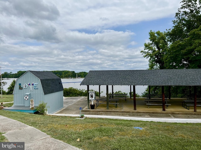 view of property's community with a gazebo, a yard, and a storage shed