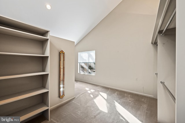 spacious closet featuring lofted ceiling and carpet floors