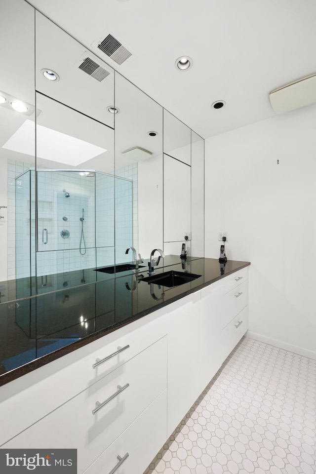 bathroom featuring vanity and an enclosed shower