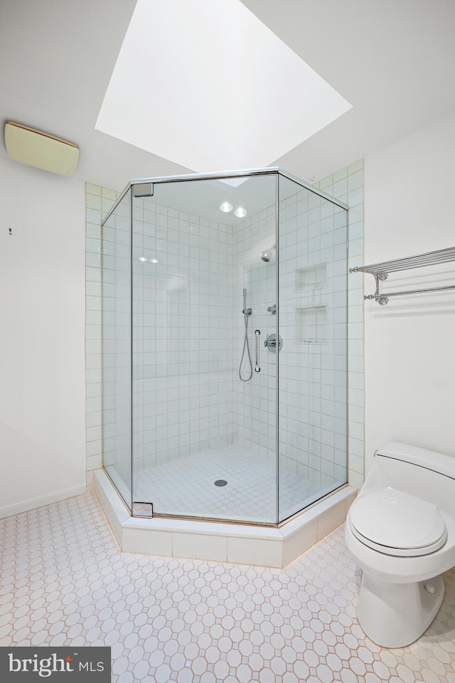 bathroom with walk in shower and toilet