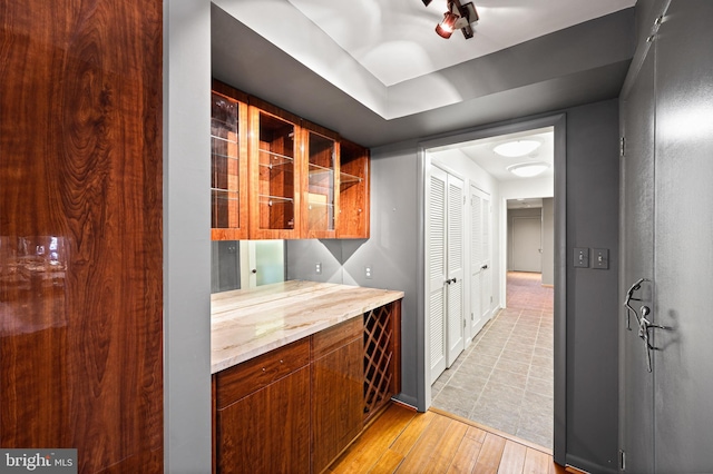 bar with light hardwood / wood-style floors