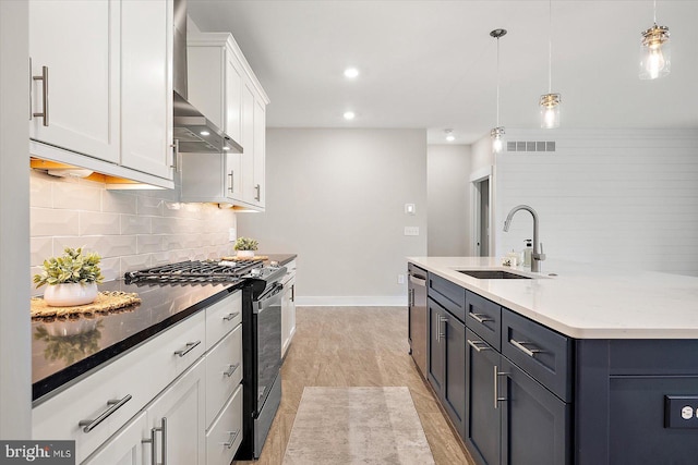 kitchen featuring backsplash, pendant lighting, sink, appliances with stainless steel finishes, and white cabinets