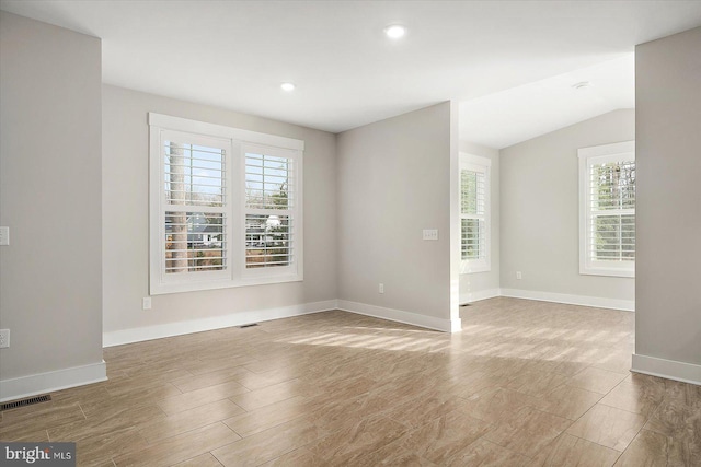 unfurnished room featuring lofted ceiling