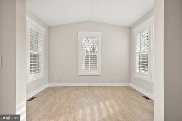 spare room with lofted ceiling