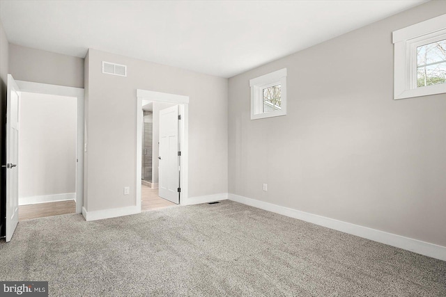 unfurnished bedroom featuring light colored carpet