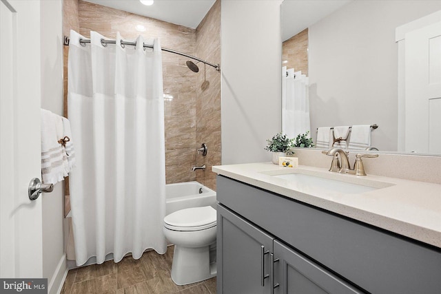 full bathroom featuring wood-type flooring, toilet, vanity, and shower / tub combo