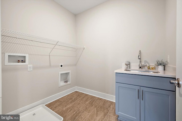 washroom featuring cabinets, washer hookup, sink, hookup for an electric dryer, and light wood-type flooring