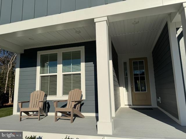 view of exterior entry with covered porch