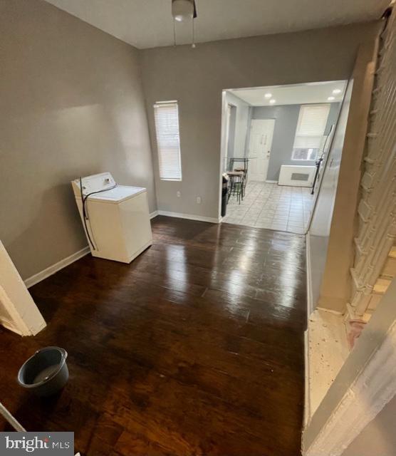 interior space with washer / clothes dryer and hardwood / wood-style floors