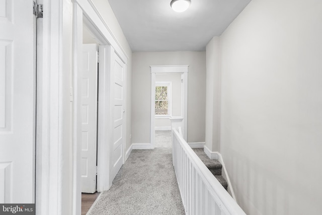 hall featuring light colored carpet