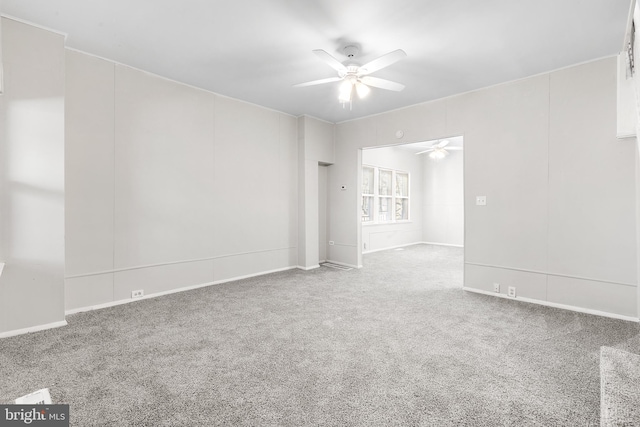 spare room featuring carpet and ceiling fan