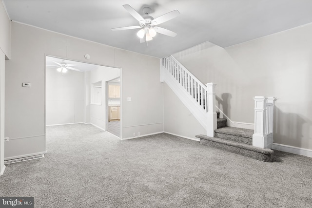 unfurnished living room with ceiling fan and carpet floors