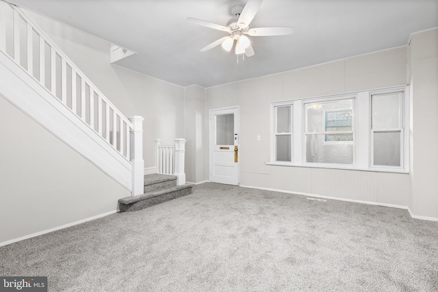 unfurnished living room with carpet flooring and ceiling fan