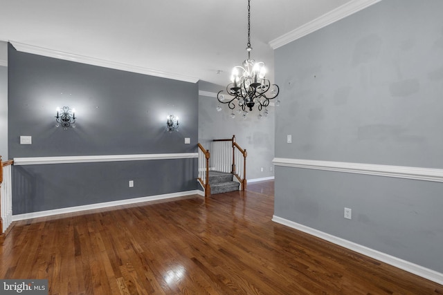 unfurnished dining area featuring crown molding, dark hardwood / wood-style flooring, and an inviting chandelier