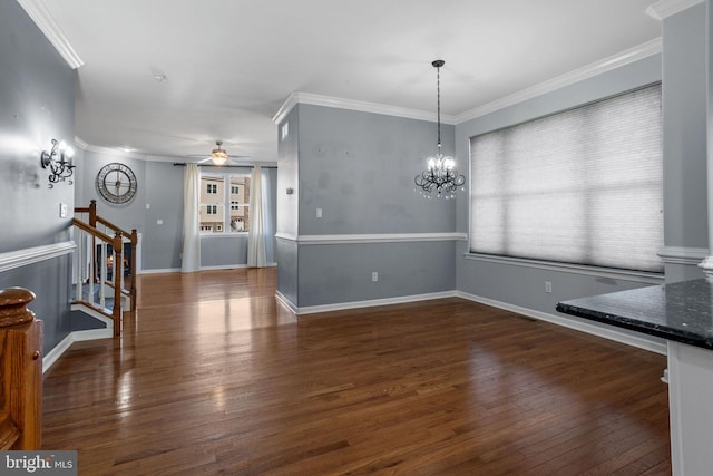 unfurnished dining area featuring crown molding, dark wood-type flooring, and ceiling fan with notable chandelier