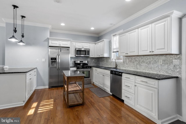 kitchen featuring sink, dark hardwood / wood-style floors, pendant lighting, white cabinets, and appliances with stainless steel finishes