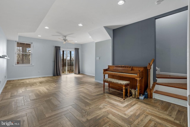 sitting room featuring ceiling fan and light parquet floors