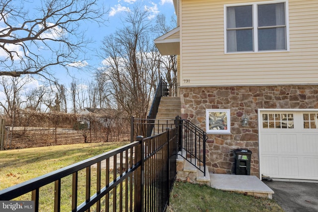 view of side of property with a yard and a garage