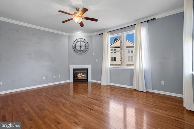 unfurnished living room with ceiling fan, ornamental molding, and hardwood / wood-style flooring