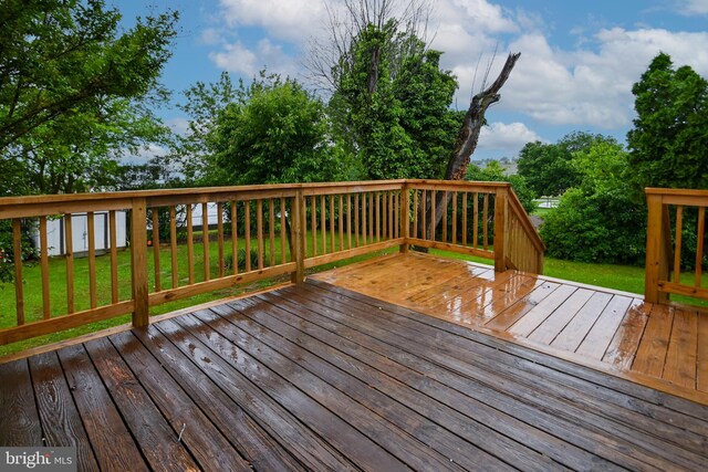 wooden terrace featuring a yard