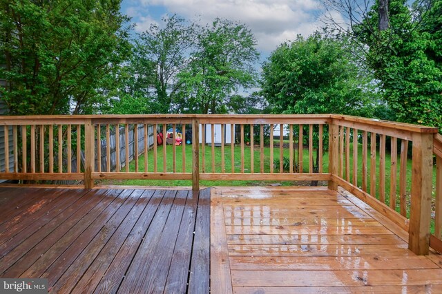 wooden terrace with a lawn