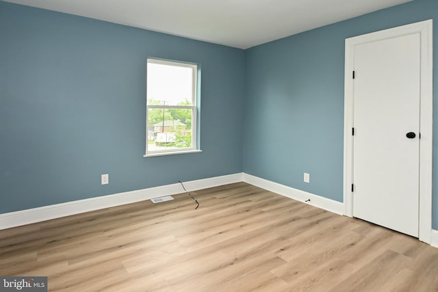 unfurnished bedroom with light wood-style floors and baseboards