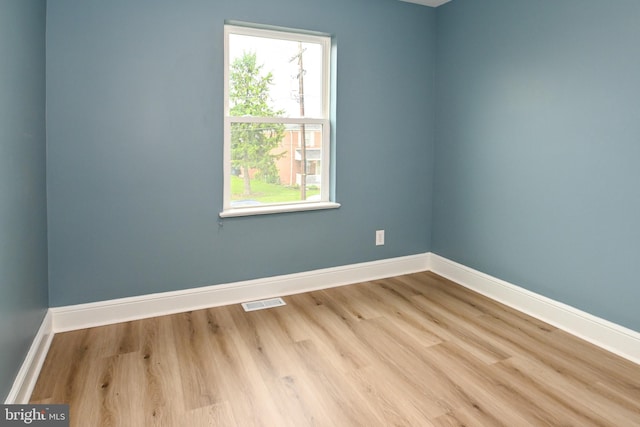 unfurnished room featuring baseboards and wood finished floors