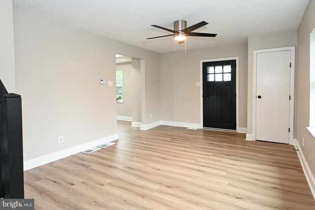 entryway featuring light wood-type flooring, baseboards, and ceiling fan